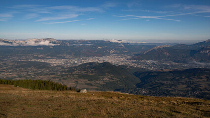 Fototapeta premium Valley with the city of Grenoble seen from the mountains of Chamrousse in summer in the Alps in France