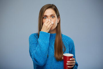 Sick woman with allergy or cold, flu sniffle into napkin. isolated portrait.