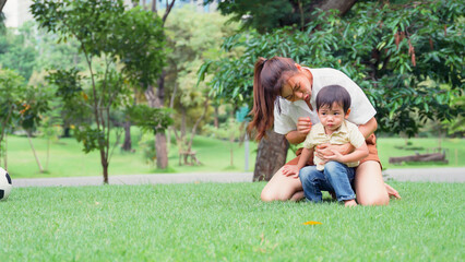 Asian young mother holding her little son.