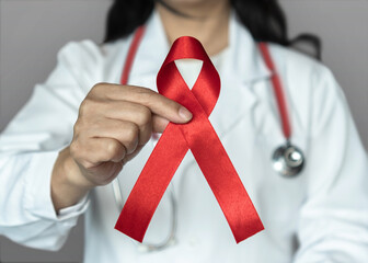 World aids day and national HIV AIDS and ageing awareness month in December with red ribbon on...