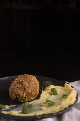 panko breaded meat with potatoes on a light fabric background