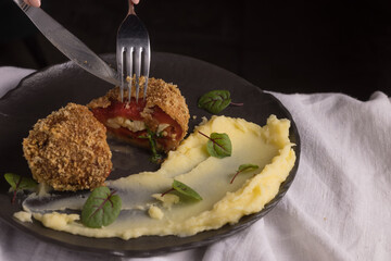 panko breaded meat with potatoes on a light fabric background