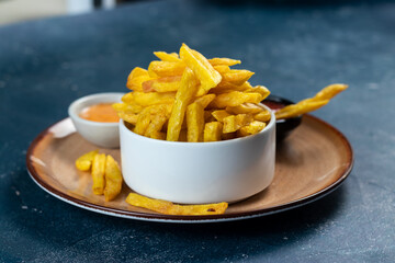 Crispy French Fries or potato chips with mayo dip and tomato sauce served in a plate side view view