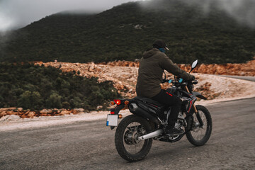 Man riding motorcycle on the road. Solo traveler 