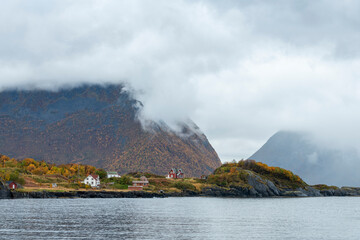 Remote houses at rocky coast, Kvaløya island, Tromso, Norway - stock photo
