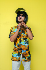 a man wearing a beach shirt and white pants