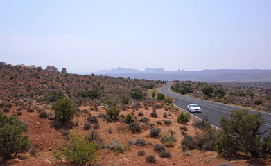 Arches national park road with car