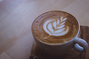 coffee hot drink cappucino latte art on wood vintage table , coffee time on wood background cafe