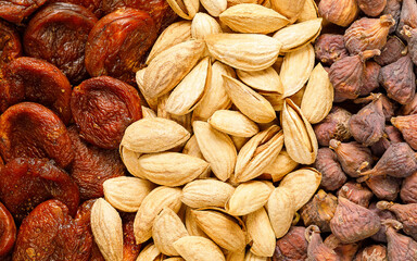 Tasty fresh almond nuts, naturally dried apricotes, naturally dried figs, background, texture. Uzbek food. Selective focus. High quality photo