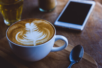 coffee hot drink cappucino latte art on wood vintage table , coffee time on wood background cafe