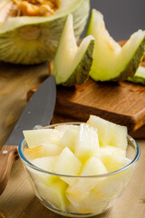Uzbek honeydew melon with seeds on wooden background. Uzbek food. Selective focus