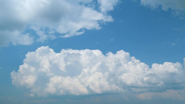Cumulonimbus cloudscape with bright white cloud formations. Clouds explode fluffy majestic. Timelapse.
