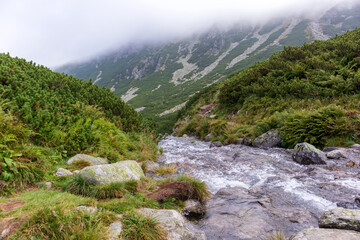 Impressive landscape with large grey-brown mountains in the Polish Tartars with a rocky hiking path