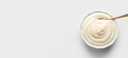 Bowl of tasty pudding on light background with space for text, top view