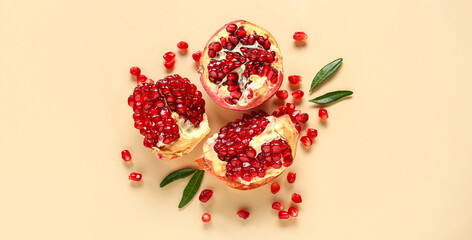 Tasty ripe pomegranate pieces on beige background