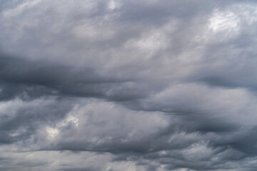 Fototapeta premium Gloomy sky with gray cumulus rain clouds during the day in the middle latitudes.