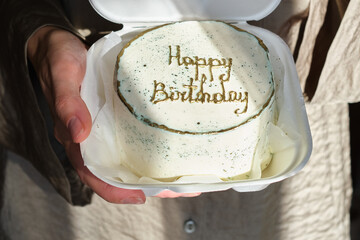 Bento cake with wishes for a Happy Birthday. Sweet gift for the holiday. Korean style cakes in a box for one person