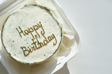 Bento cake with wishes for a Happy Birthday. Sweet gift for the holiday. Korean style cakes in a box for one person