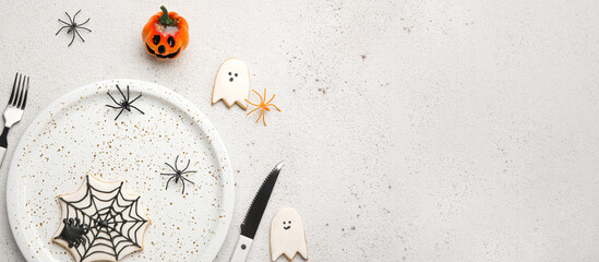 Table setting with Halloween decor on white background with space for text