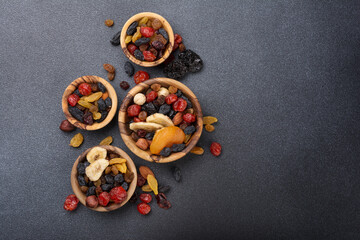 Wooden bowls with raisins, nuts and other dried fruit, berries as ingredient for tasty dessert