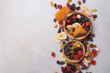 Wooden bowls with raisins, nuts and other dried fruit, berries as ingredient for tasty dessert