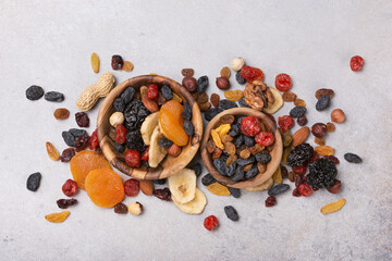 Wooden bowls with raisins, nuts and other dried fruit, berries as ingredient for tasty dessert