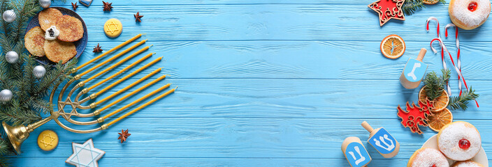 Symbols of Hanukkah and Christmas decor on color wooden background
