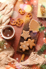 Board with sweet Christmas gingerbread cookies and cup of coffee on table