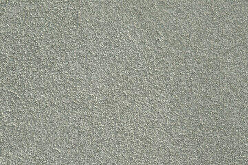 Beige cement plaster background. background formed by lime plaster near an old house on a sunny day
