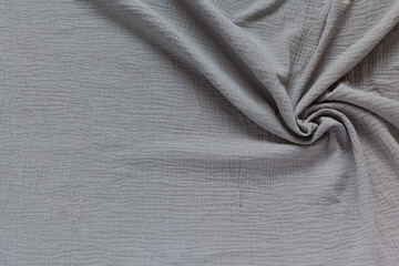 Stylish cotton wrinkled muslin fabric. Gray textile background. Base for sewing breathable, light,...