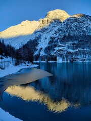 snow covered mountains at lake predil in winter on Julian Alps