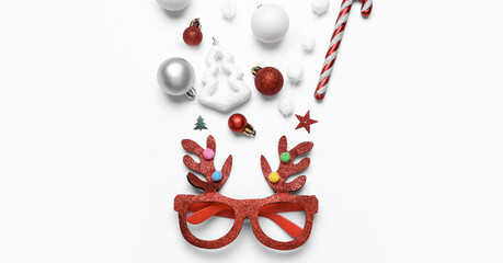 Beautiful Christmas composition with party eyeglasses on white background