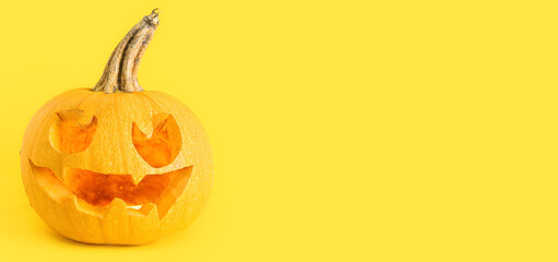 Halloween pumpkin on yellow background with space for text