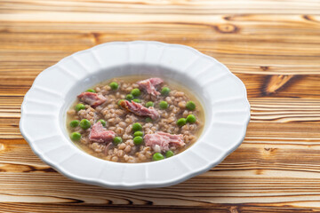 smoked meat with groats and green peas