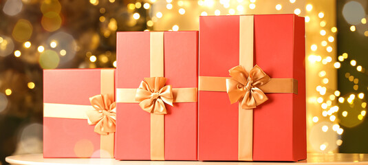 Beautiful Christmas gift boxes on table in room
