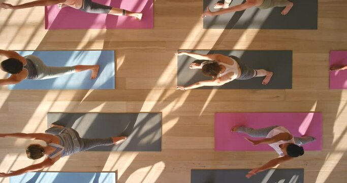 Fitness, exercise and zen yoga women meditation in a workout pilates class at a wellness studio. Above training a group of calm, relax and healthy. Practice cardio for a peace and healthy lifestyle