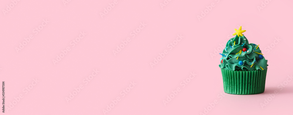 Wall mural tasty christmas cupcake on pink background with space for text