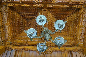 Old Javanese chandelier inside a joglo house. Javanese hanging lamp. Antique traditional lamps of java Indonesia. 