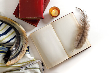 Shofar (horn), tallit, book and feather pen. Jewish holiday of Yom Kippur - day of fasting,...