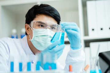 Close-up male scientist, laboratory specialist working with test tubes scientist. Chemist. Science...