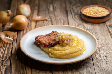 Czech cuisine, smoked meat with pea porridge and fried onion until golden