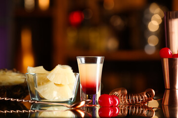 Tasty Pineapple Upside Down Cake Shot and fruits on table in bar