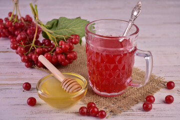 Tea from red viburnum berries with honey. The concept of healthy vitamin drinks.
