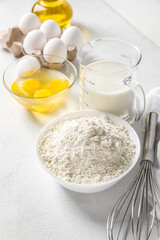 Different ingredients for baking on white table