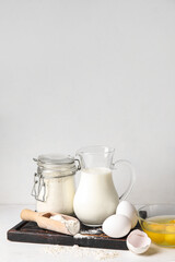 Ingredients for baking on white table against light background
