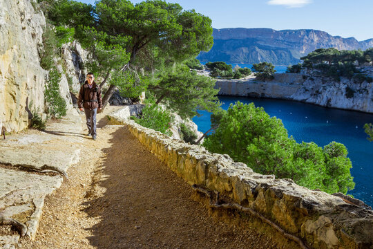 Man walking along a coastal footpath, Les Calanques, Cassis, Bouches-du-Rhone, Provence-Alpes-Cote d'Azur, France