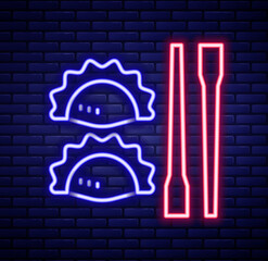 Glowing neon line Dumpling with chopsticks icon isolated on brick wall background. Traditional chinese dish. Colorful outline concept. Vector
