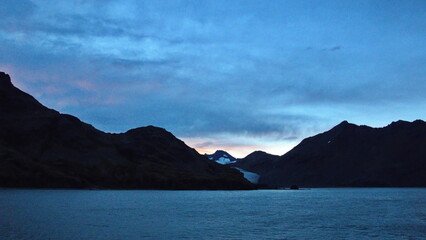 Sunset over a glacier in the mountains near Fortuna Bay, South Georgia Island