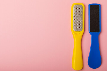 Pedicure tools.Pumice stone and foot file on a pink background. Close-up. FLAT LAY. Space for text,...