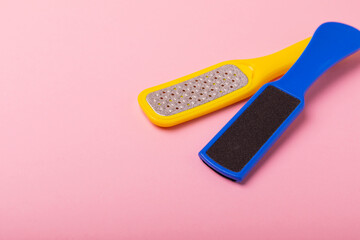 Pedicure tools.Pumice stone and foot file on a pink background. Close-up. FLAT LAY. Space for text, space for copy.